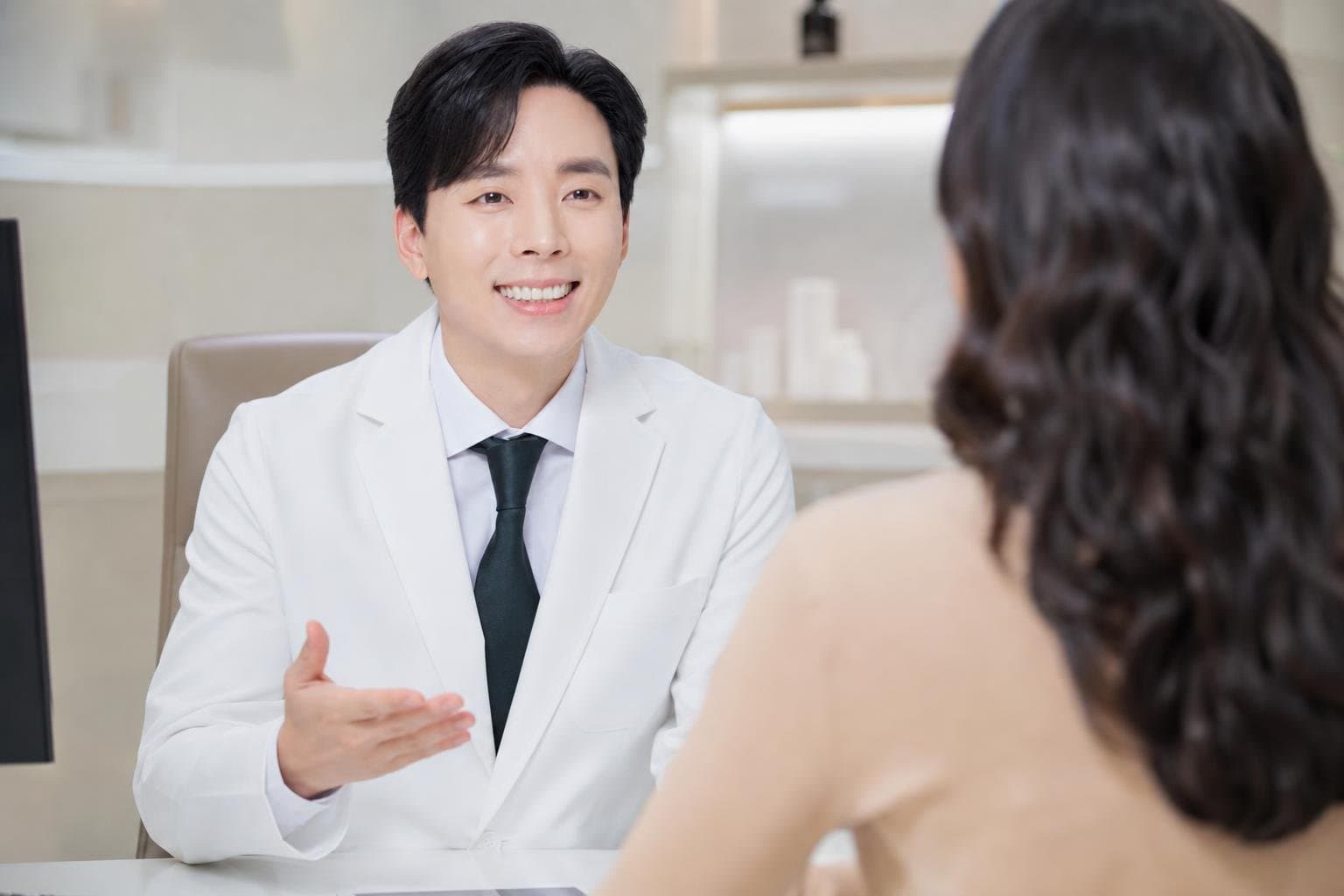 Dr. Min Jeong with a patient at REDI Dermatology in Seoul, discussing skin booster